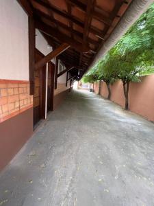 an empty hallway with trees on the side of a building at Ap próximo ao Arco com garagem in Sobral
