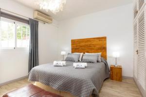a bedroom with a bed with two pillows on it at Villa in Ibiza Town with private pool, sleeps 10 in Sant Rafael de Sa Creu
