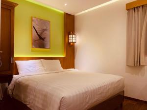 Llit o llits en una habitació de UNUMA HOTEL