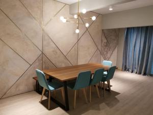 a dining room with a wooden table and blue chairs at 80 Colonie Fraser's Hill in Bukit Fraser