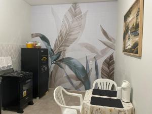 a kitchen with a plant mural on the wall at Flat hotel Victoram in Rio Branco