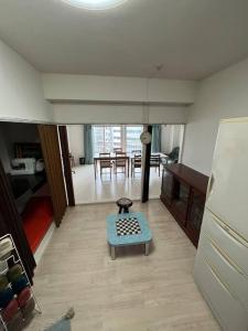 a living room with a table in the middle of a room at G&R House302 in Tokyo