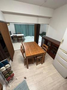 a kitchen with a wooden table and chairs in a room at G&R House302 in Tokyo