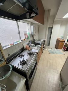 an overhead view of a kitchen with a stove and a sink at G&R House302 in Tokyo