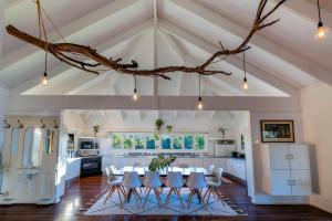 a kitchen with a table and chairs in a room at Tranquilo Beach House in Woolgoolga