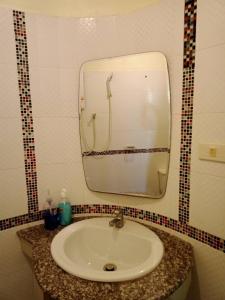 a bathroom with a sink and a mirror at Marina Seaview Krabi in Krabi town