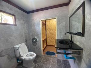 a bathroom with a toilet and a sink at Sunrise House in Ko Yao Noi