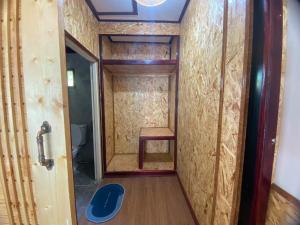 a small bathroom with a toilet and a wooden floor at Sunrise House in Ko Yao Noi