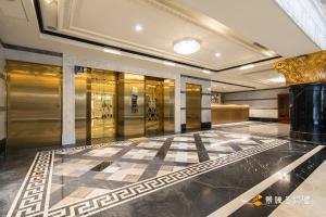 a lobby with a checkered floor in a building at Wowhappy Daan in Taipei