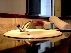 a bathroom sink with a faucet on a counter at Flamingo Hotel By The Lake, Kuala Lumpur in Kuala Lumpur
