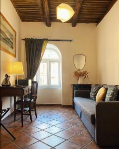 a living room with a couch and a desk at B&B Bellini in Naples