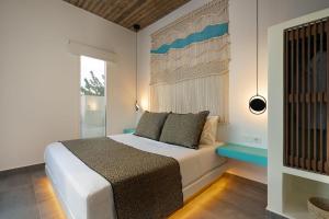 um quarto com uma cama branca e uma janela em Citrus Seaside Houses em Plaka