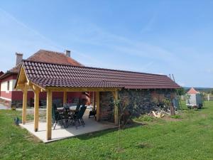 a pavilion with a table and chairs in front of a house at Petersen in Sibiu