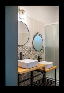 a bathroom with two sinks and a mirror at Petersen in Sibiu