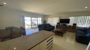 a kitchen and living room with a couch and a table at Unit 29 Seafront Estate in Jurien Bay