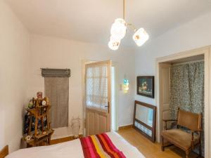 a bedroom with a bed and a chandelier at Cosy Holiday Home in Ipolydam sd in a wonderful area 