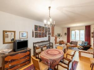 a living room with a tv and a table and chairs at Cosy Holiday Home in Ipolydam sd in a wonderful area 