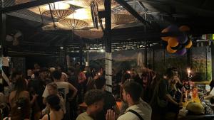 a crowd of people standing in a bar at Pokhara Backpackers Hostel in Pokhara