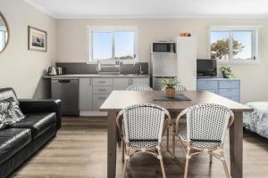 a kitchen and living room with a table and chairs at John's Place San Remo Studio Couples Surfers Pets in San Remo