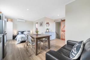 a living room with a table and a bedroom at John's Place San Remo Studio Couples Surfers Pets in San Remo