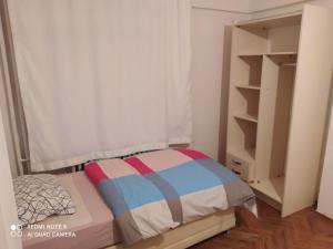 a small bedroom with a bed and a book shelf at Uncular Flat 3+1 in Istanbul