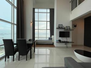 a living room with a dining table and a television at Premier Suite at Maritime in George Town