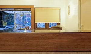 a reception desk with a mirror and a window at Itsy By Treebo - Crown Inn in Pune