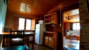 a kitchen with a refrigerator and a table in a room at Casitas La Purísima Lavanda in Requena