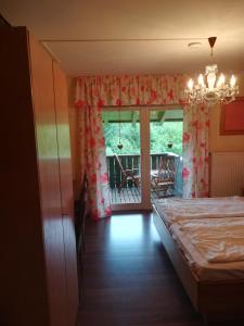 a bedroom with a bed and a chandelier at Apartment Christopherhof 56 Grafenwiesen in Grafenwiesen