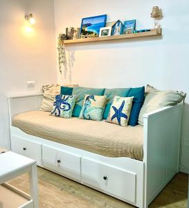 a white bed with pillows on it in a room at Il Mono del Porto - Studio Apartment in Ancona