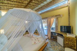 een slaapkamer met een bed met klamboe bij Villa Matahari - Cute 1 bdr villa with private pool in Gili Meno