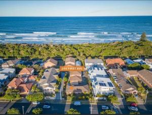 an aerial view of a home next to the ocean at The Sandy Villa 150 meters from Sawtell Beach in Sawtell