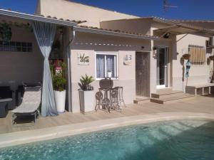 a house with a swimming pool in front of a house at Calymar in Sierra de Yeguas