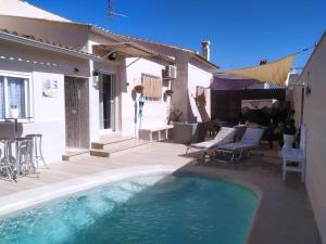 a swimming pool in the backyard of a house at Calymar in Sierra de Yeguas