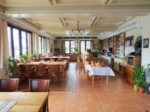 a restaurant with tables and chairs in a room at Hotel Aquamarin in Bad Mitterndorf