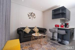 a living room with a couch and a table at Unit 700 @2SIX2 on Florida in Durban
