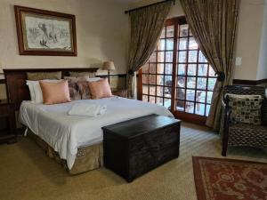a bedroom with a large bed and a large window at Khaya Africa Guesthouse in Midrand