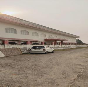 a white car parked in front of a building at Jiya Green Garden & Banquet, Sonipat in Sonīpat