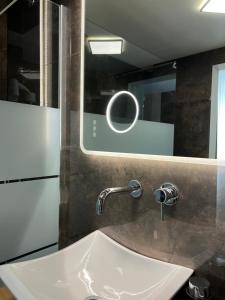 a bathroom with a sink and a mirror at Residenza N&D Luxury in Bari