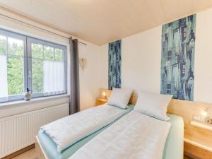 a bedroom with a bed and a window at Apartment between Winterberg and Willingen in Medebach