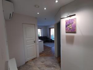 a room with a hallway with a painting on the wall at Vytauto 423 Apartments by JK in Palanga