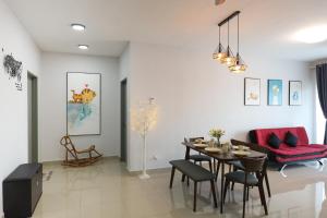 a living room with a table and a couch at Lovely 3-bedroom with Pool - Puchong for 6 Pax in Puchong