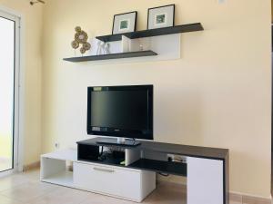 a living room with a tv on a white entertainment center at Coco in Costa Calma