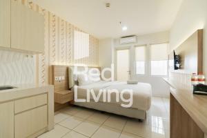 a bedroom with a bed with red living written on it at RedLiving Apartemen Sentul Tower - Skyland in Bogor