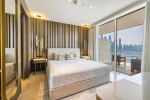 a bedroom with a bed and a view of the city at Beautiful 2BR High-Floor Marina View in Five in Dubai