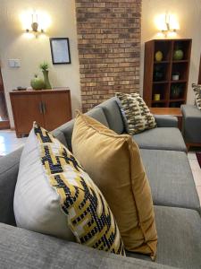 two pillows on a couch in a living room at Kruger Park Lodge, Kubu Lodge 224 in Hazyview