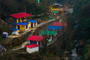 a group of houses with colorful roofs on a hill at The Hosteller Mussoorie By the Streamside, Kempty in Mussoorie