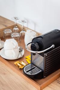 a toaster sitting on top of a wooden table at iGadi House Boutique Hotel in Cape Town