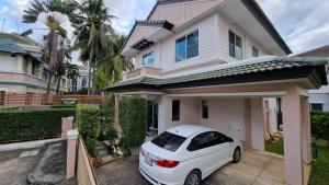 a white car parked in front of a house at Cosy House in Chiangmai in Ban Rong O