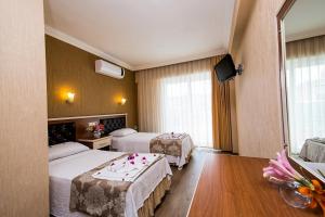 Postel nebo postele na pokoji v ubytování Epic Hotel
